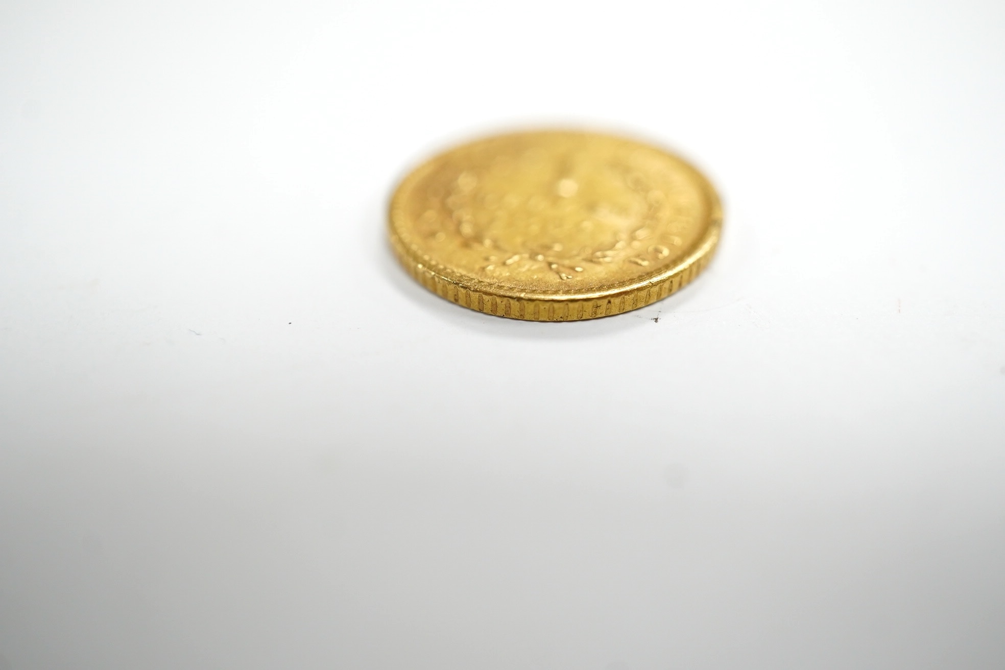 Gold coins, an early 19th Indian half rupee and USA 1851 one dollar